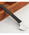 Single round cutting knife from Pro Grade Two Piece Leather Knife Set For Leathercraft in manganese steel on a wooden surface.