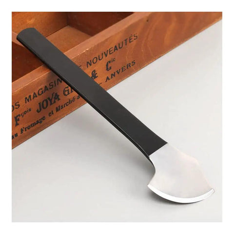 Single round cutting knife from Pro Grade Two Piece Leather Knife Set For Leathercraft in manganese steel on a wooden surface.