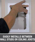 Installing Eight By Eight Inch White Access Panel For Plumbing And Electrical Cables between wall studs seamlessly.