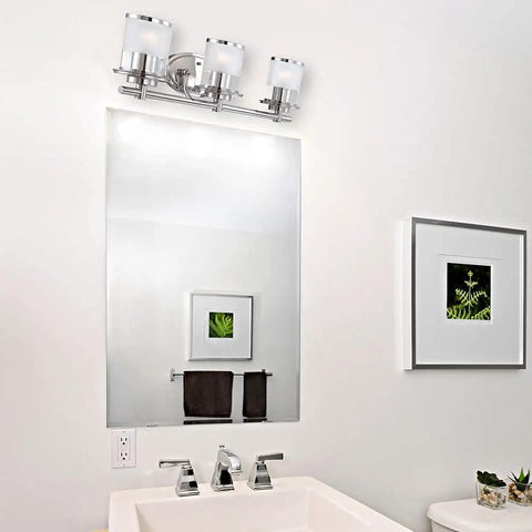 Essence 3 Light Bathroom Vanity Light Fixture in chrome above mirror with sand clear glass shades, steel construction