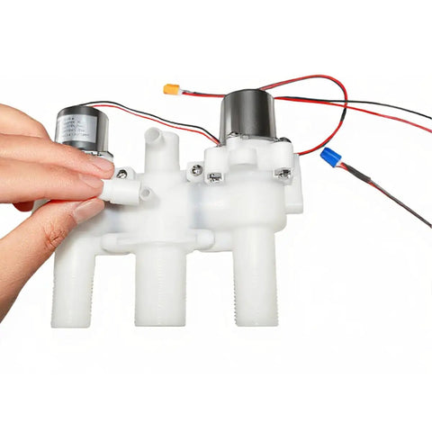Person holding 12V DC Smart Toilet Bidet Dual Solenoid Water Valve Manifold ZNF-A with wires and threaded ports for home installation