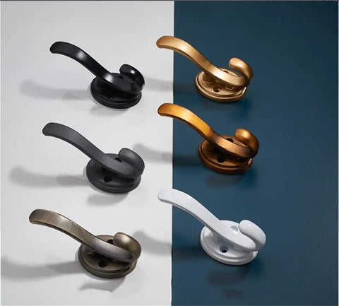 Heavy Duty Single Arch Coat Hook For Door Back Or Wall Mount Straight Up Solid Steel Build with matte finishes in black, white, and brass.