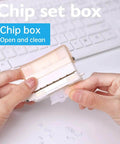 Hands holding a transparent brown Six Hole Round Paper Punch Handheld Circle Punch, pocket-size for planners, on a keyboard background.