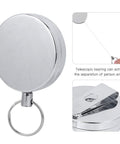 Close-up of metal retractable key ring wire keychain with belt clip anti theft anti lost design 5 cm diameter electroplated gear.