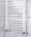 Close-up of towel radiator mounted using the Three Pack Replacement Towel Rail Radiator Brackets For Heated Walls White Finish Universal Adjustable