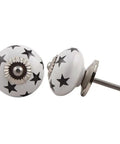 100 Pack White Star Ceramic Drawer Knobs For Kitchen Cabinets And Dressers Slick Decorative Door Pulls showing white knobs with black stars.