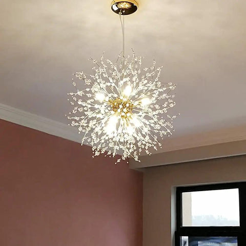 Lit Gold Crystal 9 Light Dandelion Firework Pendant Chandelier With G9 Base in room setting, clear crystals illuminated.