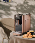 Premium Silver Espresso Coffee Machine For Your Daily Grind Compact Kitchen Drip Brewer with coffee cup and cookies.