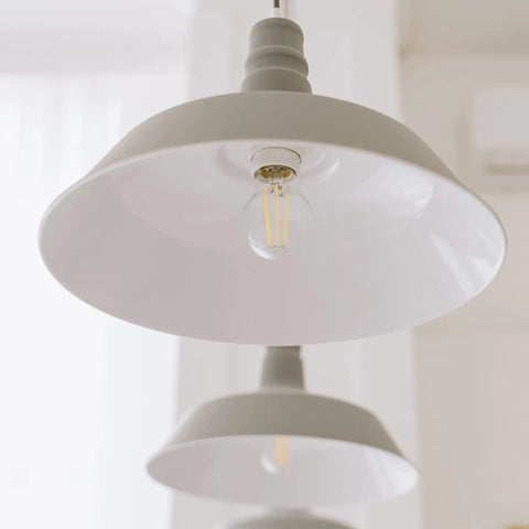 Close-up of G25 LED Filament Vanity Bulb 40W Equivalent, 500 Lumens, 2700K Warm White, installed in pendant lighting.