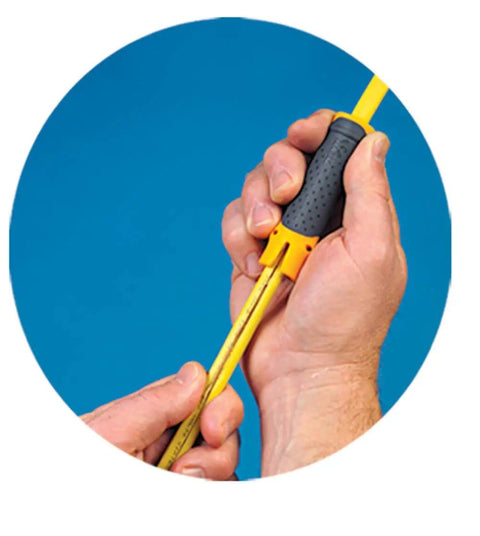 Close-up of hands using Lil Ripper Wire Stripper With Slitting Blade on a yellow cable against a blue background