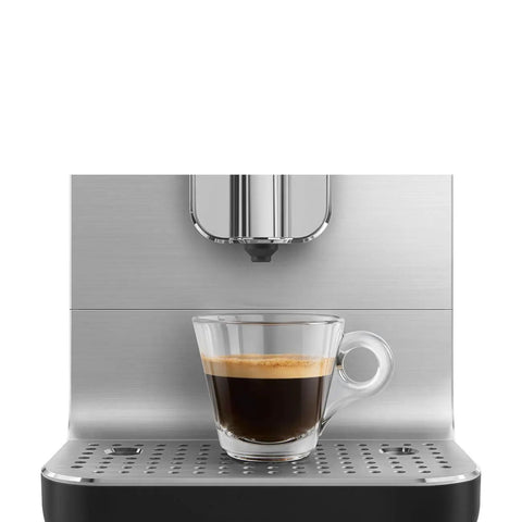 No Sweat Brewing Fully Automatic Espresso Machine With Integrated Grinder And One Touch Milk Frother For Silky Lattes Bold Shots And Ten One Tap Presets 19 Bar Pressure Compact Space Saving Matte Black brewing a shot of espresso in a glass cup.