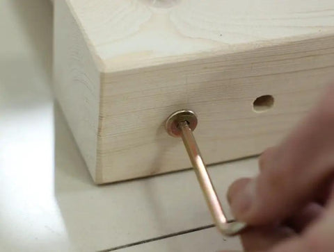 Close-up of M8 X 120mm Hex Drive Socket Cap Furniture Barrel Nuts And Bolts Set for repairing a wooden frame.