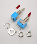 Two blue mini SPST toggle switches, front view, with red caps, 3 pins, threaded shafts; includes nuts and washers.