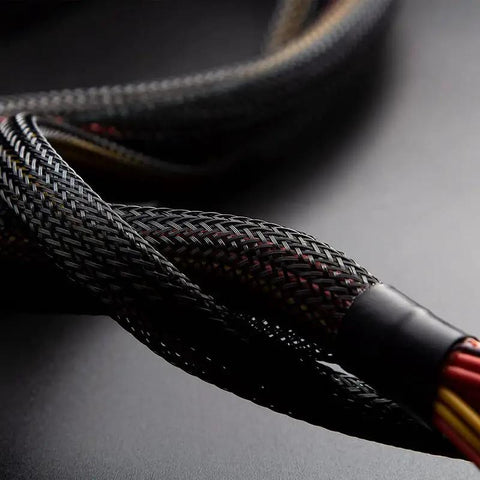 Close-up of 100 Ft PET expandable braided wire sleeving, 1/4 inch black cable loom protecting wires, flexible sleeve for multiple uses.