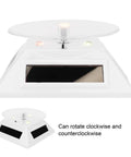 Xhtllo Electric Led Light Solar Powered Rotating Turntable Display Stand For Jewelry Phunique Watches Camera And Decorations, front view with lights
