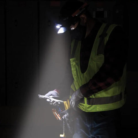 Worker using Rechargeable Two Color LED Headlamp with Durable Fabric Strap, Spotlight and Floodlight Modes in dark environment.