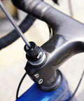 Close-up view of Road Bike Shifter Angle Measure Tool Adapter in use on a black bicycle handlebar, showcasing precise alignment features.