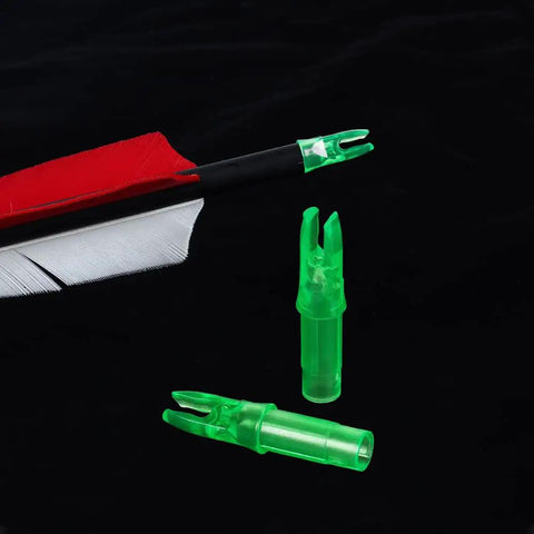 Green Press-In Arrow Nocks For Carbon Arrows.244/.246 Throat, 50 Pack Plastic Nocks next to arrow, black background