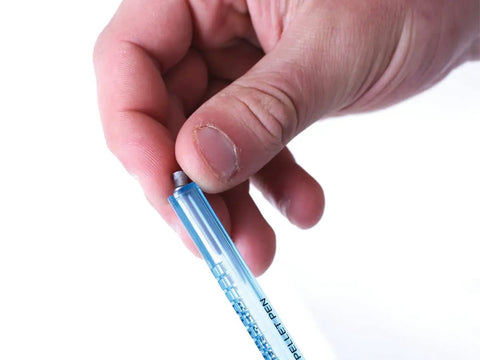 Hand holding Dope Pellet Pen Holds 20 177 Cal Pellets Slick Reload Clip Kit Magazines Included Hassle Free Ammo Storage