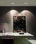 Recessed LED Ceiling Light, Downlight illuminating a desk area with modern decor and a black wall art piece.