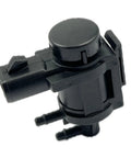 Close-up of DEVMO 4x4 hub lock vacuum actuator, black plastic with round top and two hose ports