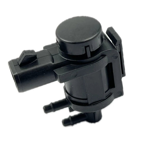Close-up of DEVMO 4x4 hub lock vacuum actuator, black plastic with round top and two hose ports