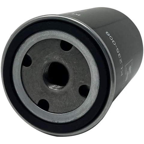 Close-up of black cylindrical oil filter for air compressor with 3/4 inch 16 thread replacement part, showing metal base with holes.