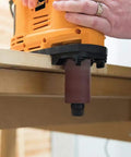 Heavy Duty 650W Portable Oscillating Spindle Sander With Variable 1800 To 3200 RPM Speed sanding an edge on a wooden surface.