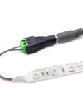 Close-up of LED strip connected to a 12V DC Power Supply For LED Strips 2A 24W Switching Adapter with barrel connector