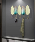Heavy Duty Iron Wall Mounted Coat Hooks And Scarf Organizer With Sleek Geometric Lines, four hooks holding keys and a scarf.