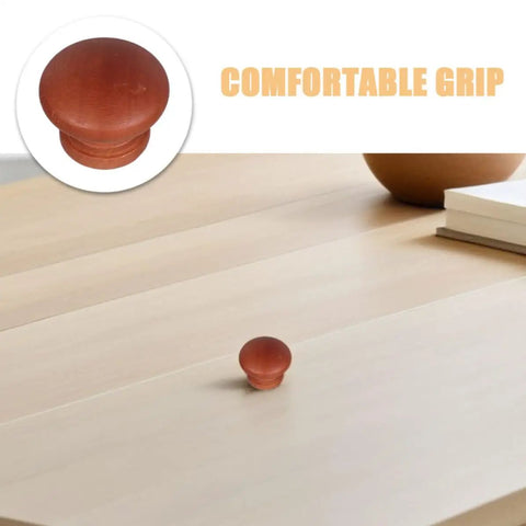 8 Pack Wood Dresser Knobs With Classic Brown Tone Provide Quick Cabinet And Drawer Handle Replacement To Instantly Liven Up Your Kitchen Or Bedroom With Effortless Setup And Timeless Vintage Vibes, showcasing a round wooden knob on a light wooden surface.