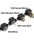 Four black motor mounting brackets with screws and nuts for N20/N30 motors (front view).