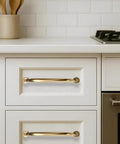 3 Inch Hole Center Brushed Brass Cabinet Pulls 10 Pack installed on white kitchen drawers, showing clean and modern look.