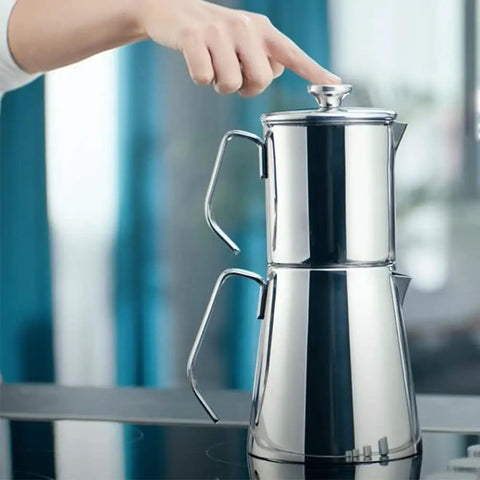Aqua Turkish Teapot Set In Eighteen Ten Stainless Steel With Double French Press Samovar Style Kettle With Metal Handles on stove.