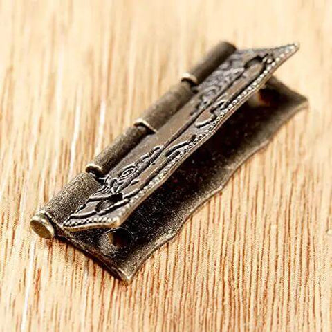 Antique Bronze Iron Hinge Set 36x23mm 10 Pieces Vintage Flower Pattern Decorative Hardware, close-up on wooden surface