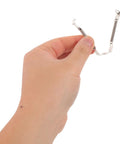Hand holding Spring Loaded Tube Retainer Clip from Five Pack For Guitar Amps And Vintage Audio Gear Easy Install Metal Socket Retainers