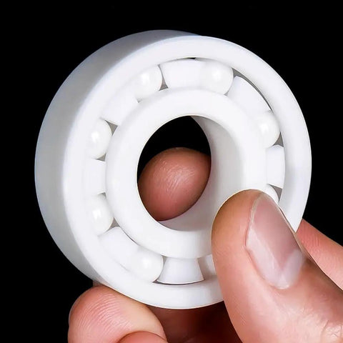 Top Tier Zirconia Full Ceramic Ball Bearings Run Ultra Fast And Stay Cool Under Load, 80x140x26mm, held in hand.