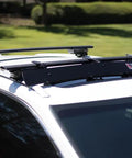 Heavy Duty Universal Roof Rack Bar Cover In Matte Black Aerodynamic Shell on a white pickup truck rooftop.