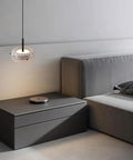 Resin Pendant Light, Gold 3 Color LED Hanging Fixture for Living Room above stylish nightstand in modern bedroom.
