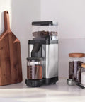 Barista-Grade Coffee Grinder With 50 mm Flat Steel Burrs And Stepless Grind Size Dial on kitchen counter with coffee beans.