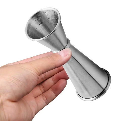 Hand holding Double Jigger Cocktail Set 1oz/2oz Stainless Steel Barware For Home Bar Use With Clear 3/4oz 1/2oz Markings