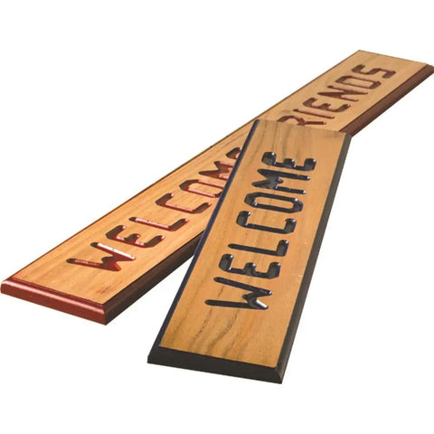 Knockout Sign Making Kit For Router Stencils with engraved 'WELCOME' and 'FRIENDS' wooden signs, showing custom woodworking projects.