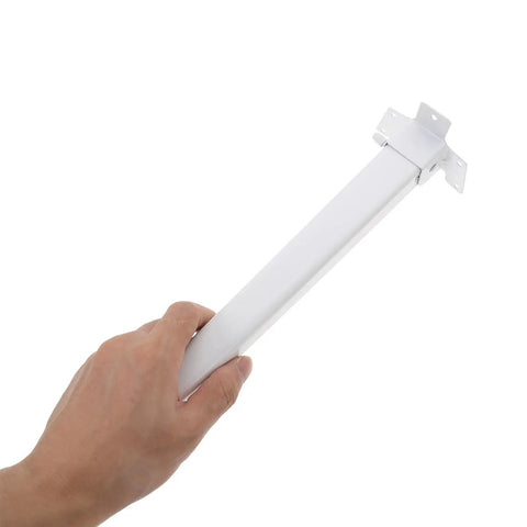 Hand holding a foldable white plastic leg with a sturdy iron core, part of four piece replacement table legs for window sill and coffee tables.