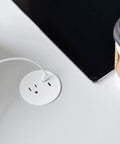 Round Furniture Power Center With USB Ports 1 Outlet USB Type A And USB C 6 Foot Cord White Low Profile Mount on a desk surface