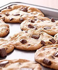Freshly baked cookies on a Perforated Aluminum Sheet Pan 13 Inch By 18 Inch Half Size Heavy Duty Workhorse Commercial Bakeware.