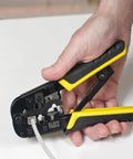 Hand holding a crimp tool from the Coax Installation Kit With Crimp Tool, Cable Cutter, Stripper, F Connectors And Storage Bag