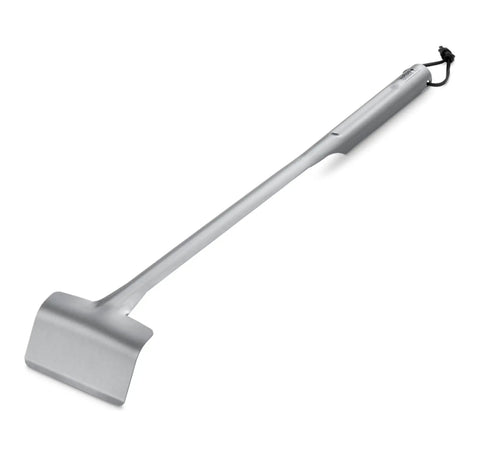 Stainless steel grill spatula with long handle on white background