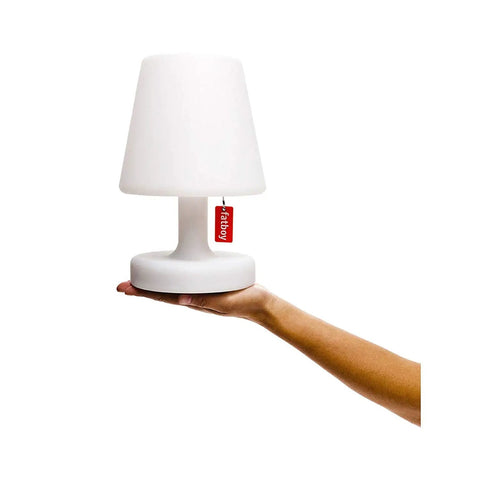 Petit LED Lamp with cordless portable power and rechargeable battery held on a hand, white finish, slim modern design, pull tag visible.