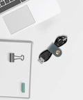 Five Piece Artificial Leather Cord Organizer With Portable Cable Ties For Earphones on a desk with a USB cable.