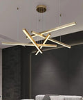 Geometric Linear LED Pendant Light Featuring Sleek Gold Finish Dimmable 3 Color Options Abstract Hanging Design with intersecting bars above modern furniture.